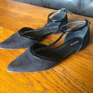 Black flats with a pointed toe and strap